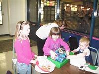 Catriona opens presents with help from Emma and Graham